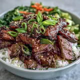 Homemade Teriyaki Beef Bowl with tender beef and crisp broccoli served over white rice.