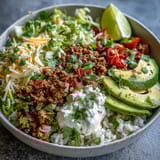A colorful Turkey Taco Bowl with seasoned ground turkey, fresh vegetables, and creamy avocado over rice.  