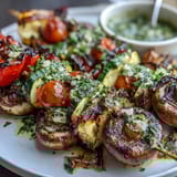 Vibrant grilled vegetable skewers with chimichurri, showcasing colorful bell peppers and zucchini.  