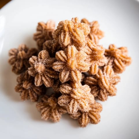 Golden, crispy Churro Bites glistening with cinnamon sugar, a perfect easy dessert.