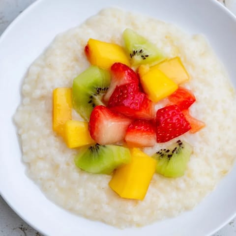 Steaming bowl of Tapioca Pudding topped with fresh berries, a delightful dessert.
