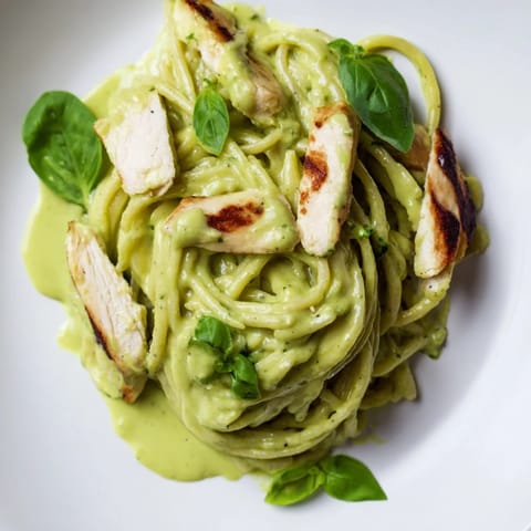 Creamy avocado chicken pasta showcases tender grilled chicken nestled in luscious avocado sauce tossed with hot noodles, ready to serve.  