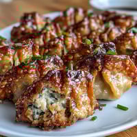 Crispy, golden smashed gyozas with a savory pork filling and napa cabbage, ready to dip in tangy soy-vinegar sauce.  