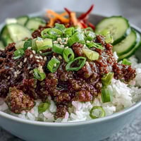 Savory Korean Ground Beef Bowl with seasoned meat, fluffy rice, and vibrant pink pickled vegetables.
